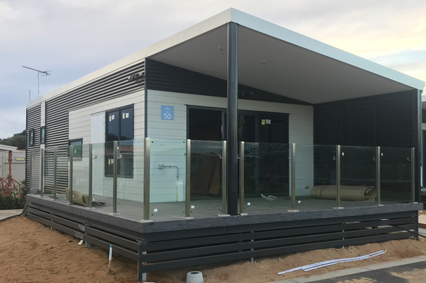 Modern modular home with outdoor deck and glass railing, showcasing Rapid Modular WA's innovative designs for residential properties in Perth.