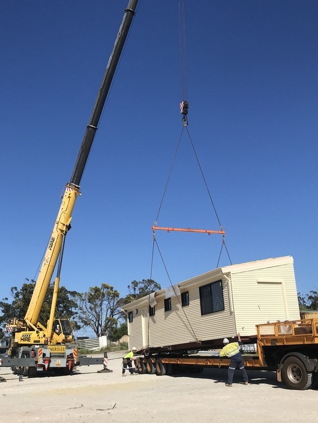 Large industrial crane lifting a prefabricated modular home for on-site assembly, showcasing Rapid Modular WA's seamless construction process in Perth, Western Australia.