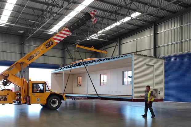 Large industrial crane lifting a prefabricated modular home for on-site assembly, showcasing Rapid Modular WA's seamless construction process in Perth, Western Australia.