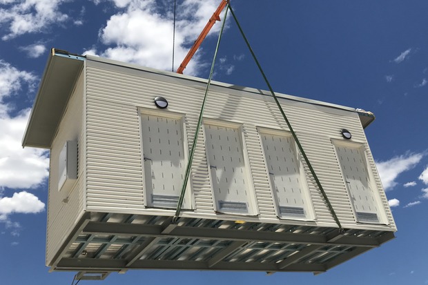 Prefabricated modular building being lifted by crane for installation, highlighting Rapid Modular WA's fast deployment of modular housing solutions for disaster recovery, emergency housing, and remote locations in Australia.