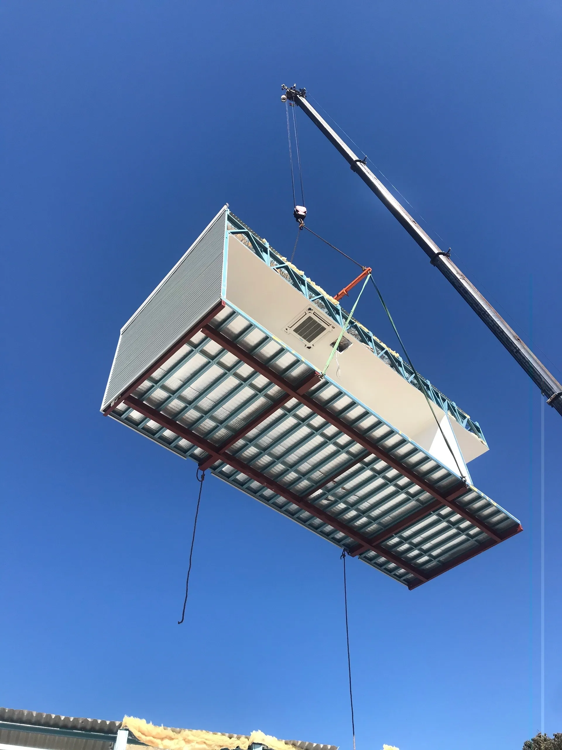 Modular housing unit being precisely lifted by crane for seamless installation, showcasing Rapid Modular WA's efficient construction methods in Perth and surrounding regions.